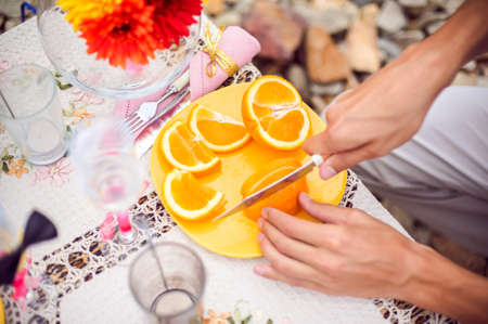Table for a romantic picnic on a rocky beach, a romantic dinner on the nature conceptの写真素材