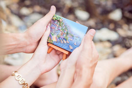 The young couple sees a picture in which painted seaの写真素材