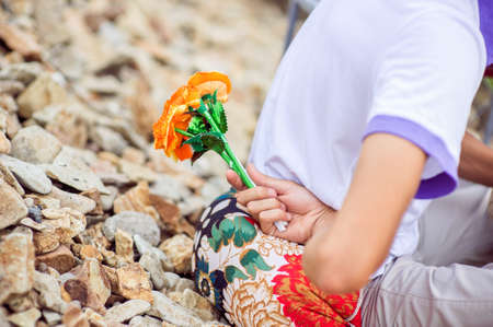 A Man hiding behind a paper flowerの写真素材