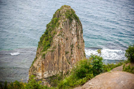 High acute Cliff by the sea, wavesの写真素材