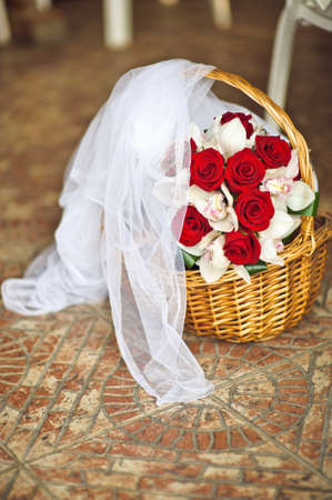 Basket, bouquet of roses and veil bride.の写真素材