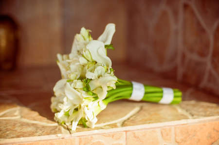 Beautiful bouquet of lily of the bride on the mantelpieceの写真素材