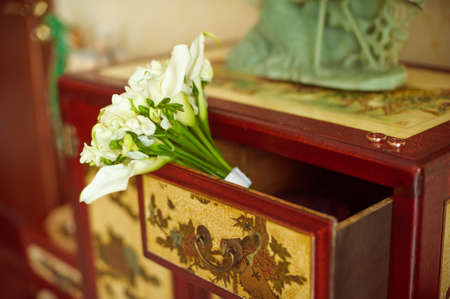 Wedding bouquet of lilies on the dresserの写真素材