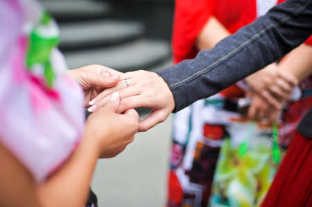 Girl shows her friends her wedding ringの写真素材