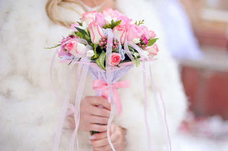 Bride with Pink Bouquet with roses in winterの写真素材
