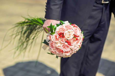 Pink Bouquet of roses in the groom's handの写真素材