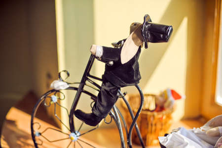 figurines of hares on a tricycle on the windowsillの写真素材