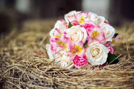 Wedding bouquet of flowers in the hayの写真素材
