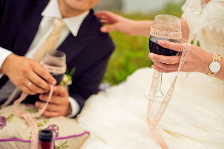 The bride and groom drink red wineの写真素材