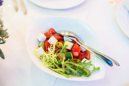 Greek salad with fresh vegetables, feta cheese and olivesの写真素材