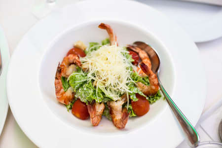 Shrimp salad with cheese, tomatoes and fresh herbsの写真素材