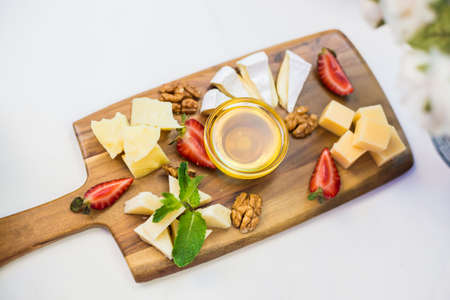 Cheese Platter with Honey Dip and Strawberriesの写真素材
