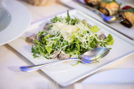 Salad with chicken hearts, arugula and Parmesanの写真素材