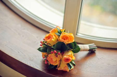Orange bridal bouquet on a window sill, Wedding conceptの写真素材