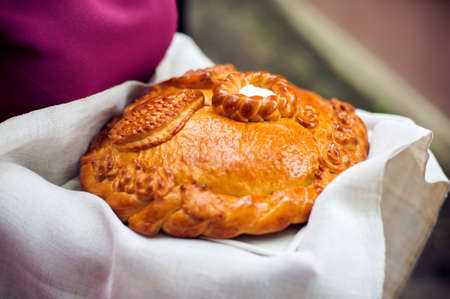 Bread-and-salt welcome. A traditional ritual of offering bread and salt to a welcome guest.の写真素材