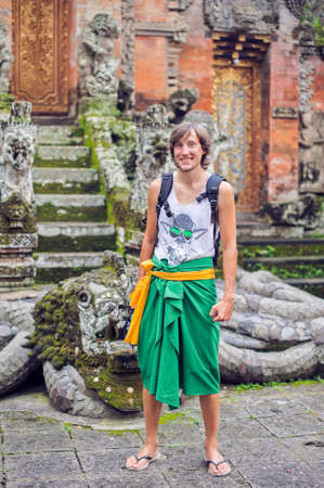 A man stands against the backdrop of a Hindu temple, Bali, Indonesiaの写真素材
