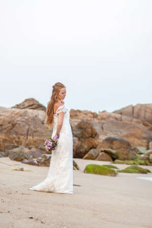 Beautiful young bride on the tropical beachの写真素材