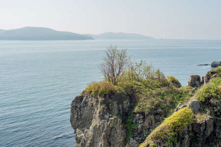 Rocks, cliffs, cold sea spikelets and blue skyの写真素材