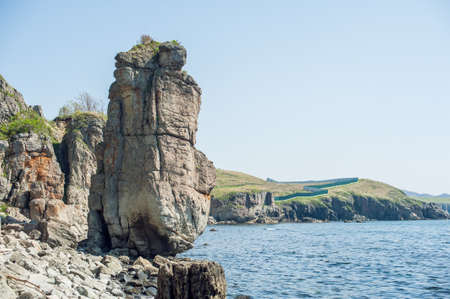 Rocks, cliffs, cold sea spikelets and blue skyの写真素材