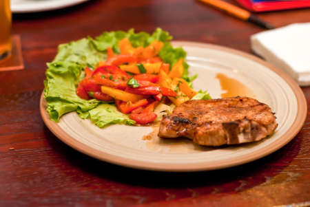 Steak with vegetables on a white plate ready for extraditionの写真素材