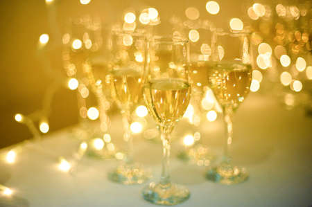 The Wedding Banquet. Banquet in the restaurant. Glasses of champagne in several rows on a mirror tray on the table with a white tablecloth.の写真素材