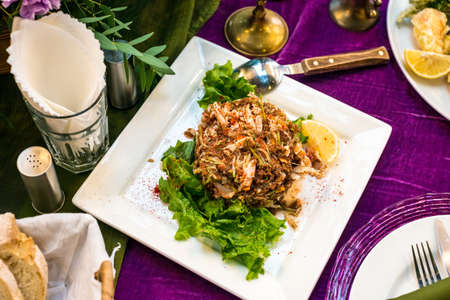 Warm salad with seafood and herbs, catering service