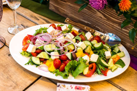 Greek salad on a white oval plate, catering serviceの写真素材