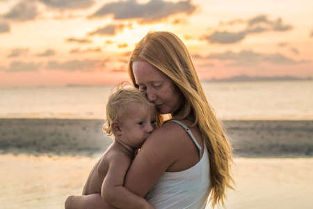 Young woman with child in the sea, holiday conceptの写真素材