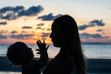 Young woman with child in the sea, holiday concept