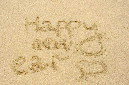 Inscription Happy new year on the beach in the sandの写真素材
