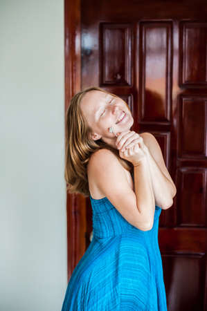 A happy young woman holds the key to the apartment or house. The lucky winner Owning real estate concept.の写真素材