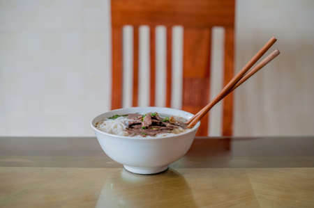 Traditional Vietnamese beef soup pho on a wooden background. Vietnamese food conceptの写真素材