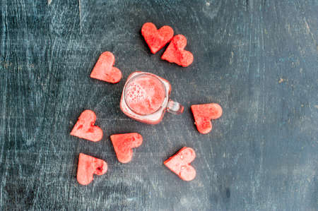 Water melon cut into heart shape. Watermelon smoothie. Flat lay composition. love concept. Valentine's Day Conceptの写真素材