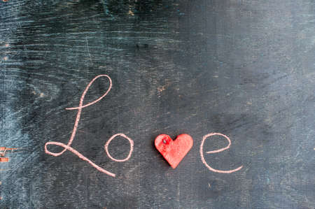Water melon cut into heart shape. Inscription love with chalk. Flat lay composition. love concept. Valentine's Day Conceptの写真素材