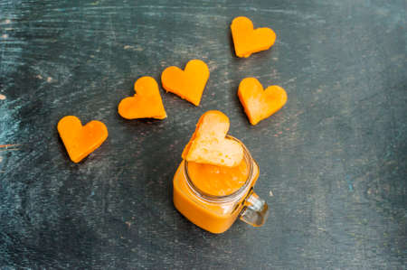 Papaya cutting shape of the heart. Papaya smoothies. The flat lying structure. love concept. Valentine's Day. Healthy food concept.の写真素材