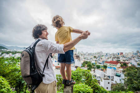 Happy tourists dad and son in Long Son Pagoda. Travel to Asia concept. Traveling with a baby concept.の写真素材