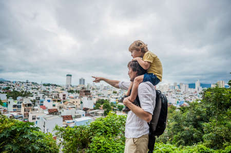 Happy tourists dad and son in Long Son Pagoda. Travel to Asia concept. Traveling with a baby concept.の写真素材