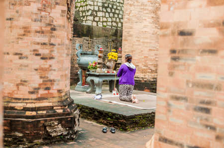 A woman prays in Po Nagar Cham Tovers. Asia Travel concept. Journey through Vietnam Concept.の写真素材