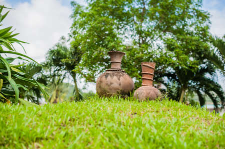 Antique vase on green grass. Asia Travel concept. Journey through Vietnam Concept.の写真素材