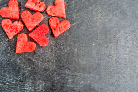 watermelon hearts on the old wooden background. Space for text. Flat lay composition. love concept. Valentine's Day Conceptの写真素材