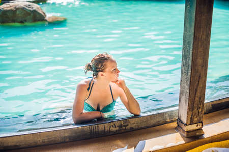 Young woman relaxing in the pool. Vacation conceptの写真素材
