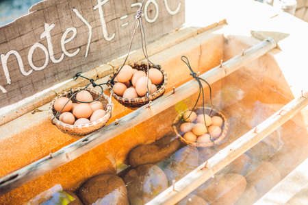 Hot natural underground thermal water is used to boil chicken eggs in some volcanic activity area. The eggs that you can cook in hot water for a hot springの写真素材