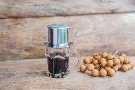 'Phin' traditional Vietnamese coffee maker, place on the top of glass, add ground coffee then pour hot water and wait until the coffee dripping into the glass.の写真素材