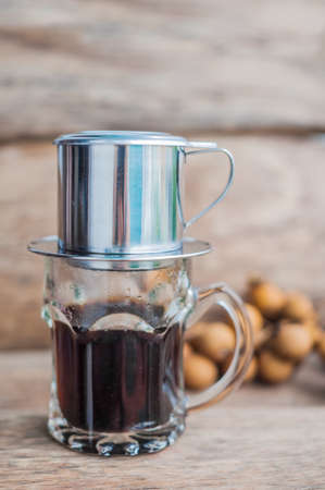 'Phin' traditional Vietnamese coffee maker, place on the top of glass, add ground coffee then pour hot water and wait until the coffee dripping into the glass.の写真素材