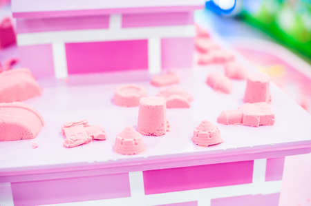 Figures from the pink kinetic sand The development of fine motor concept. Creativity Game concept.の写真素材