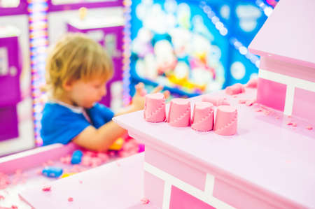 Boy playing with kinetic sand in preschool. The development of fine motor concept. Creativity Game concept.の写真素材