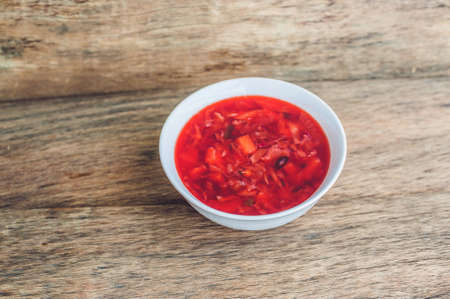 Traditional Ukrainian Russian vegetable borscht soup on the old wooden background and vegetables. Russian and Ukrainian food conceptの写真素材