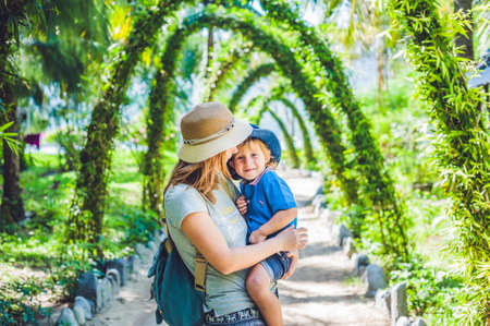 Mother and son in a tropical garden. Family Holidays conceptの写真素材
