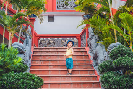 Boy tourist in Buddhist temple in Vietnam Nha Trang, Traveling with children conceptの写真素材