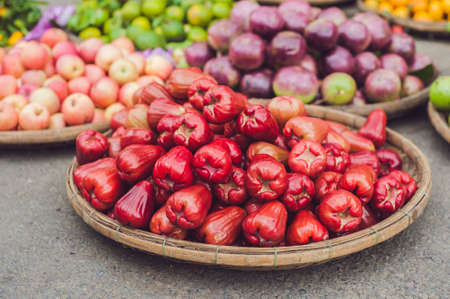red rose apples, homphu, Syzygium cumini, yambozaili or Malay apple, also called wax, pink, mountain or water apple, in the Vietnamese market.の写真素材